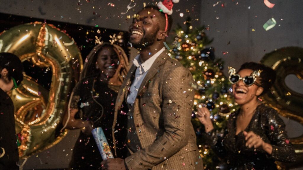 A man and his wife celebrating the arrival of the new year with their friends and family